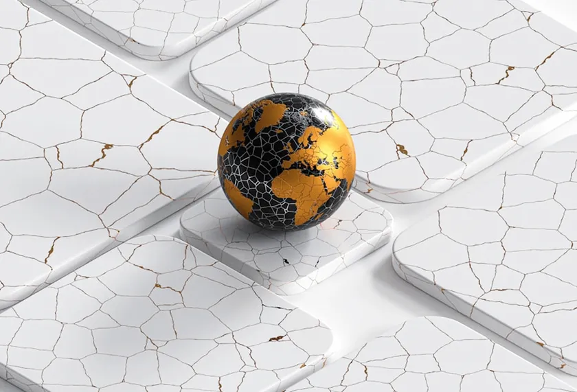 Golden globe on a cracked white surface